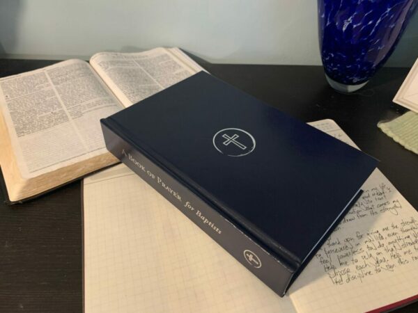 Open bible, journal, and A Book of Prayer for Baptists