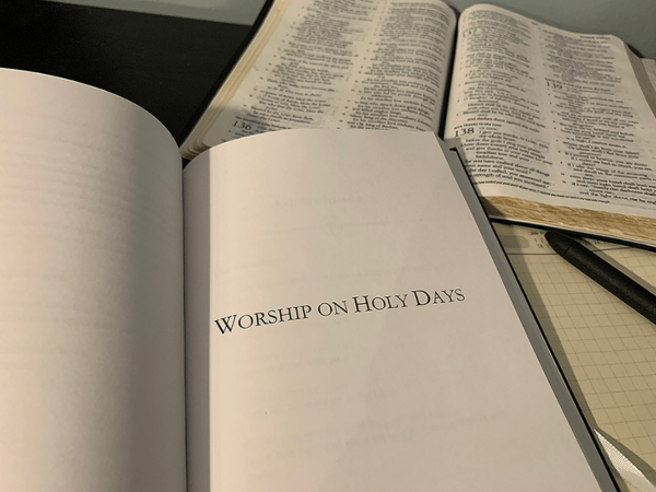 open bible, pen, journal, and A Book of Prayer for Baptists open to Worship on Holy Days