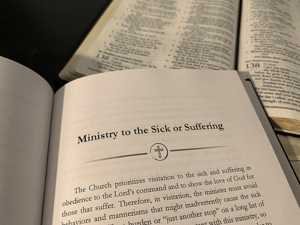 open bible, and A Book of Prayer for Baptists open to Ministry to the Sick or Suffering